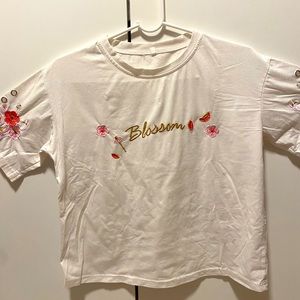 White T-Shirt with Embroidery Flowers and the Word “Blossom”
